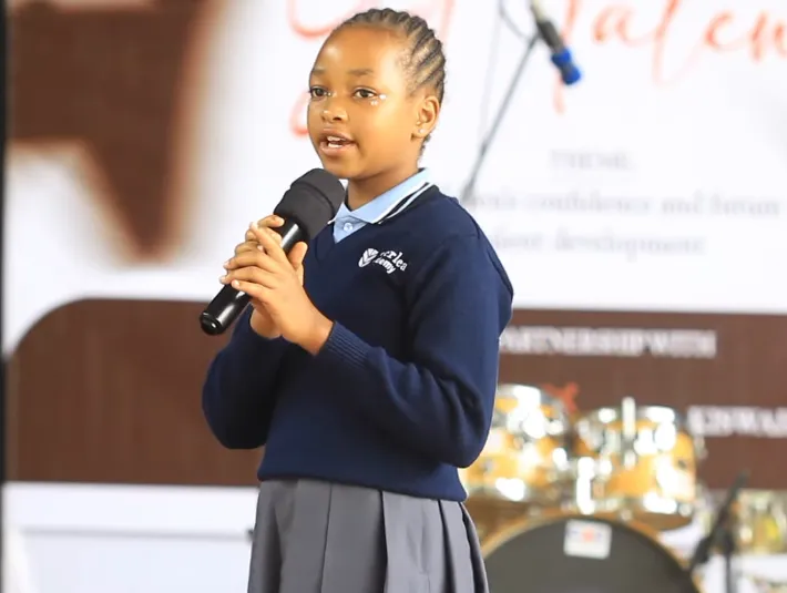 Young performer singing confidently on stage