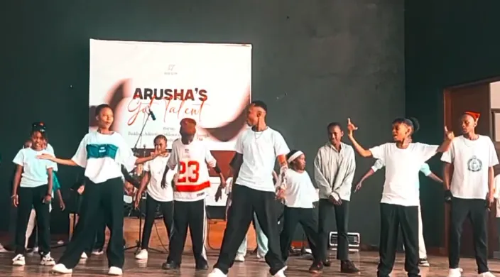 Young performer showcasing talent on stage at Arusha's Got Talent event